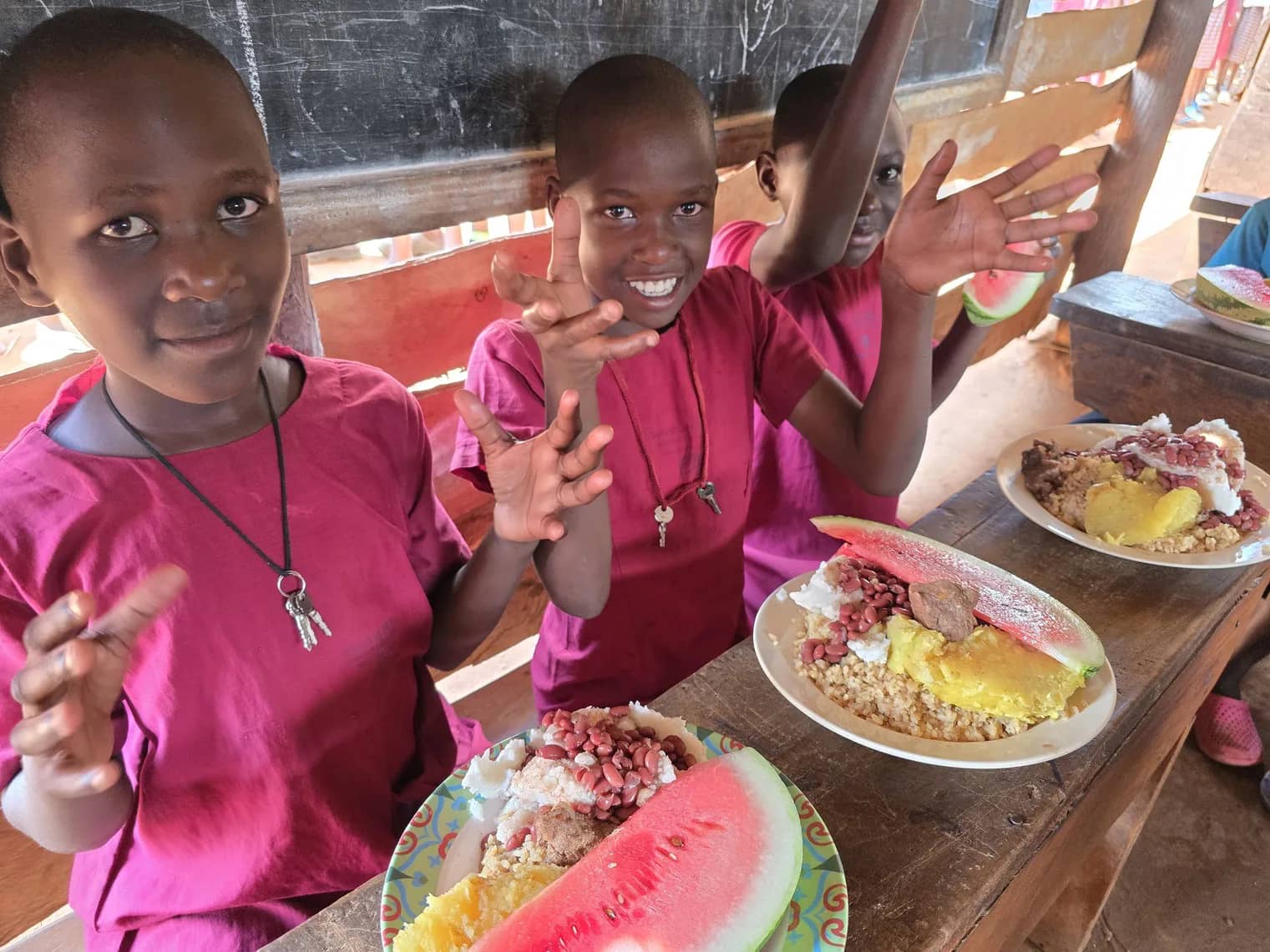 Children sit together to eat.