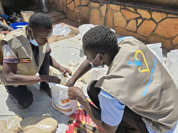 Team members fill a food package together.