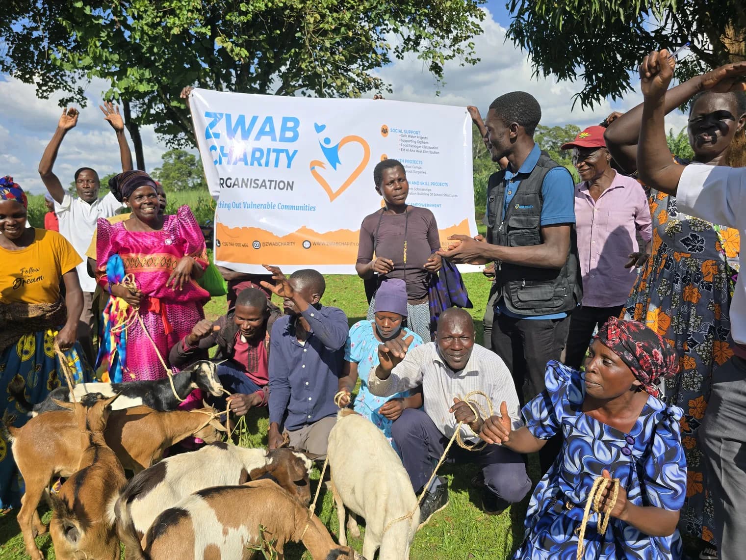 Community members and a Zwab team member gather with live goats.