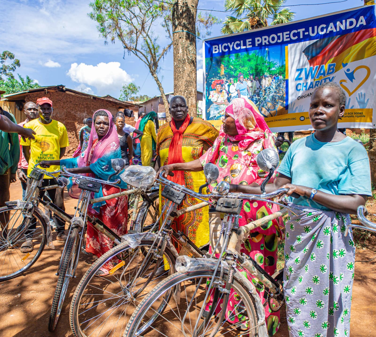 A woman and a man stand beside a bicycle at a community event.