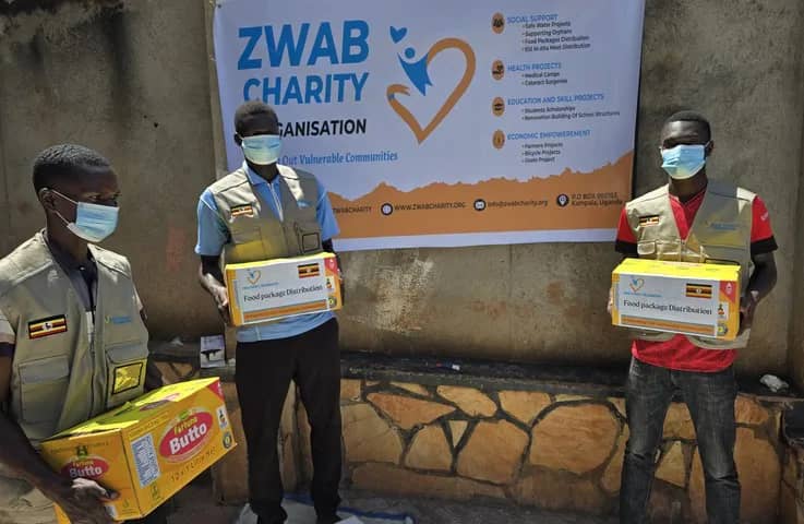Team members hold food supplies before packing.