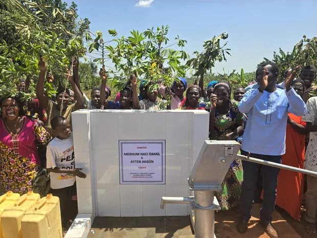 Community members gather around a water point.